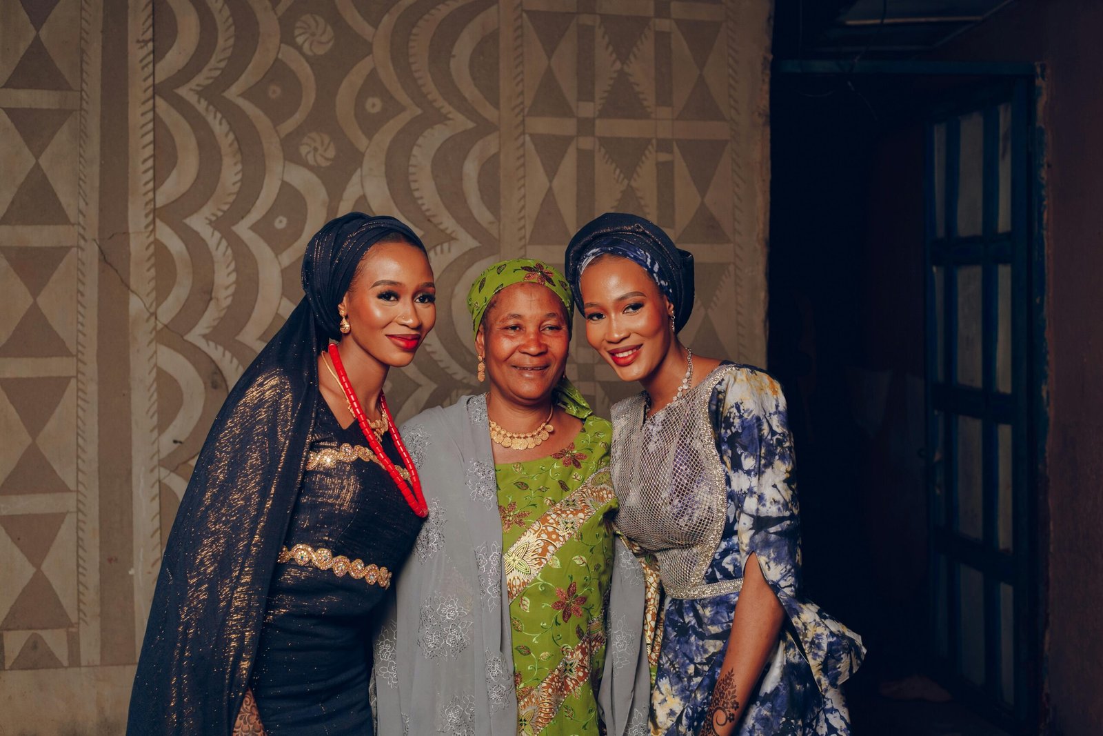 three African women at a cultural event