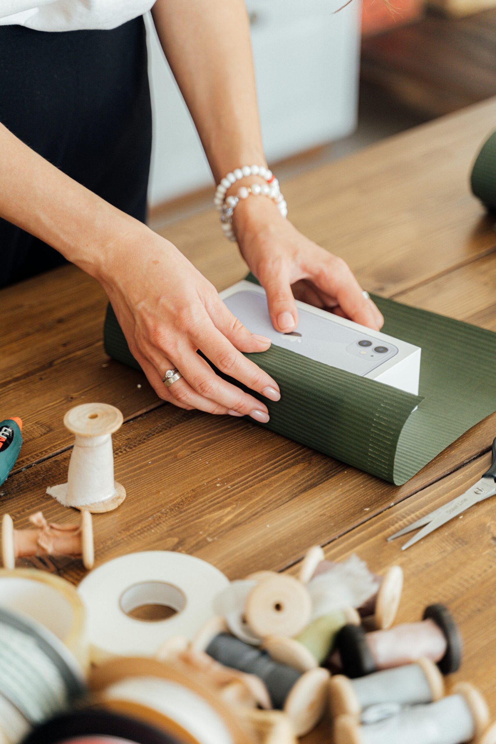 a person wrapping a new iphone